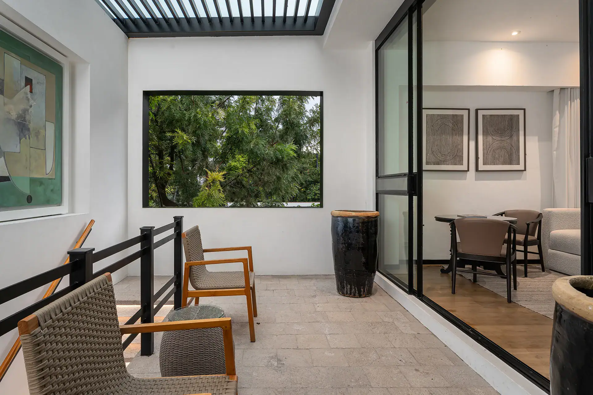 Villa del Parque Central, balcony with woven chairs and a large window leading to a bedroom sitting room, San Miguel de Allende