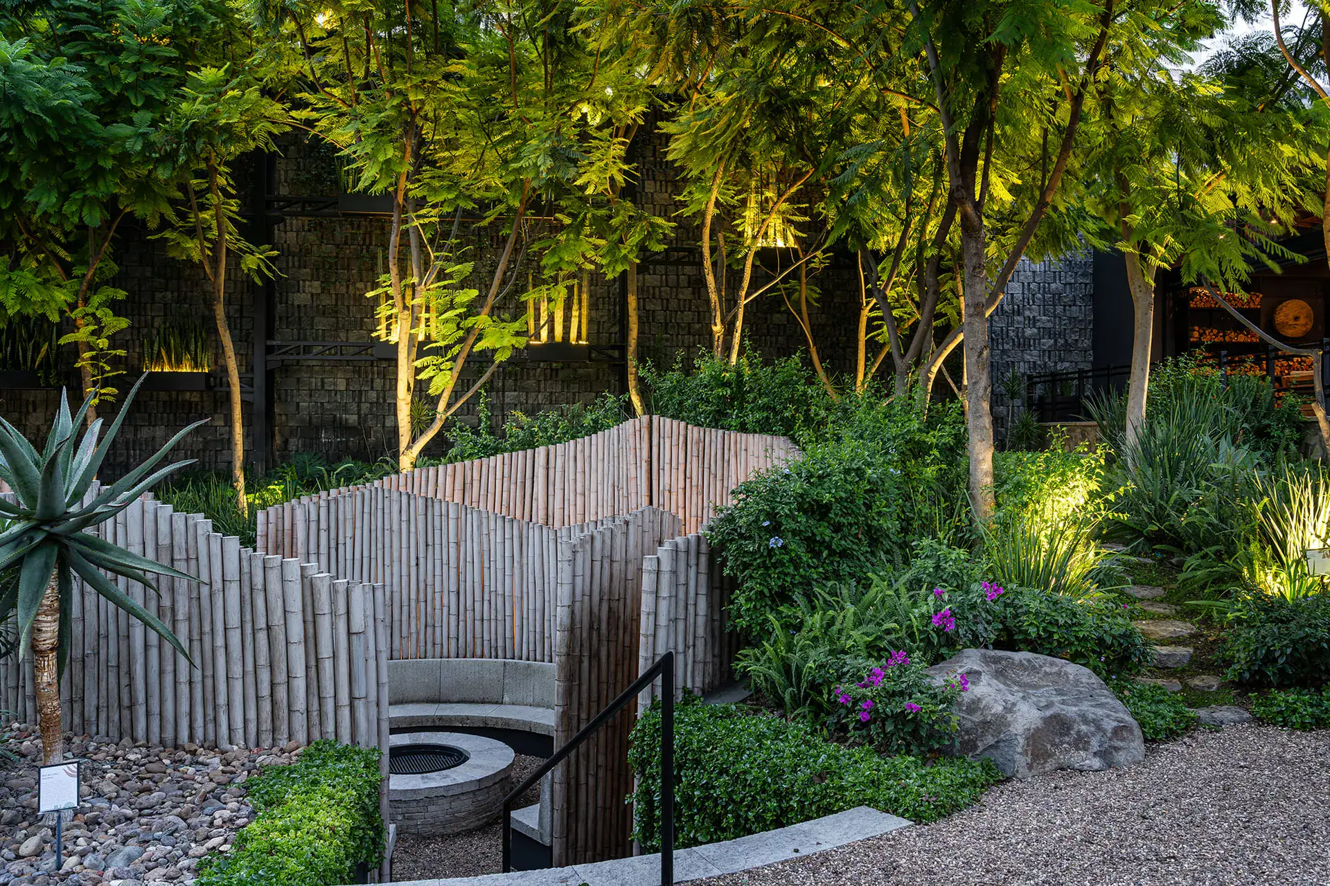 Villa del Parque Central, sunken fire pit seating area enclosed by bamboo-like screens in the garden, San Miguel de Allende