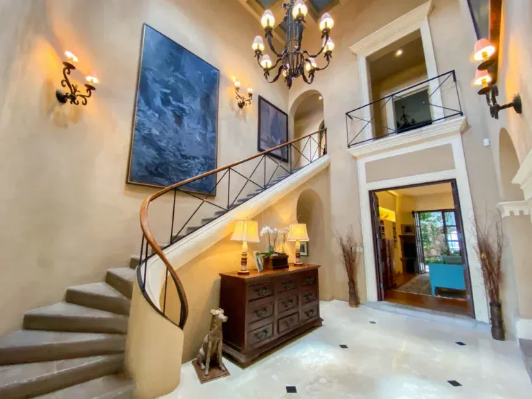 Villa Entre Sueños, entry hall with a spiral staircase and a wrought-iron chandelier, San Miguel de Allende