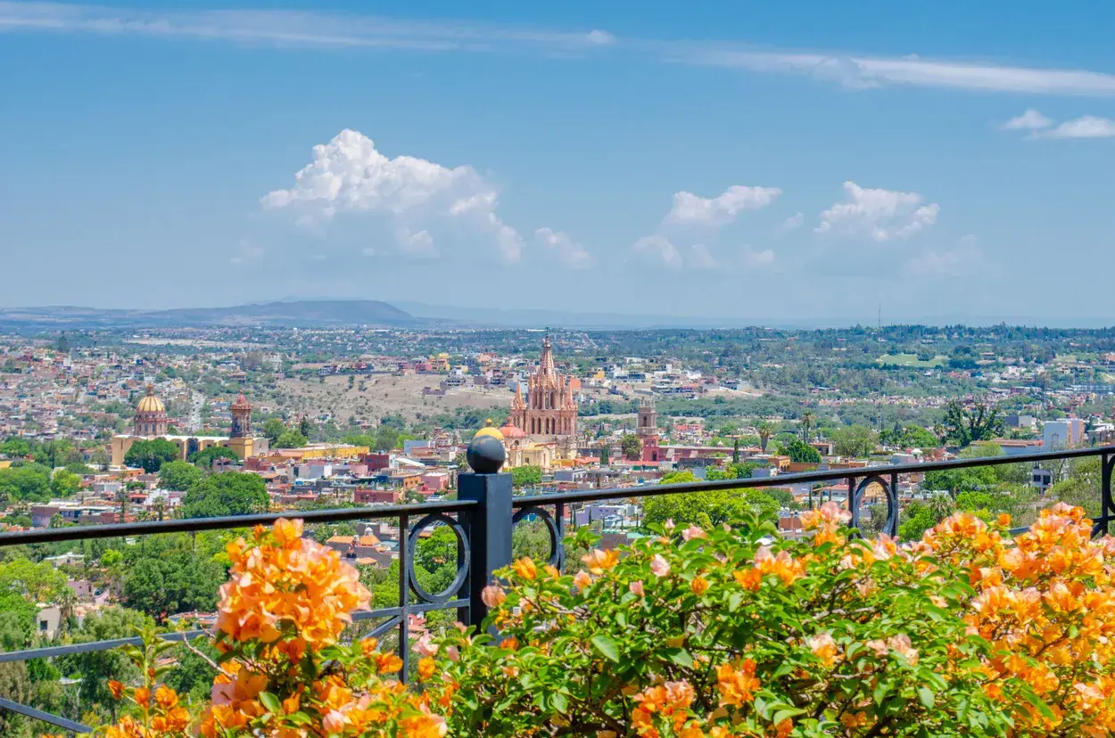 Villa Entre Sueños, city view from a terrace with bougainvillea and the Parroquia in the distance, San Miguel de Allende