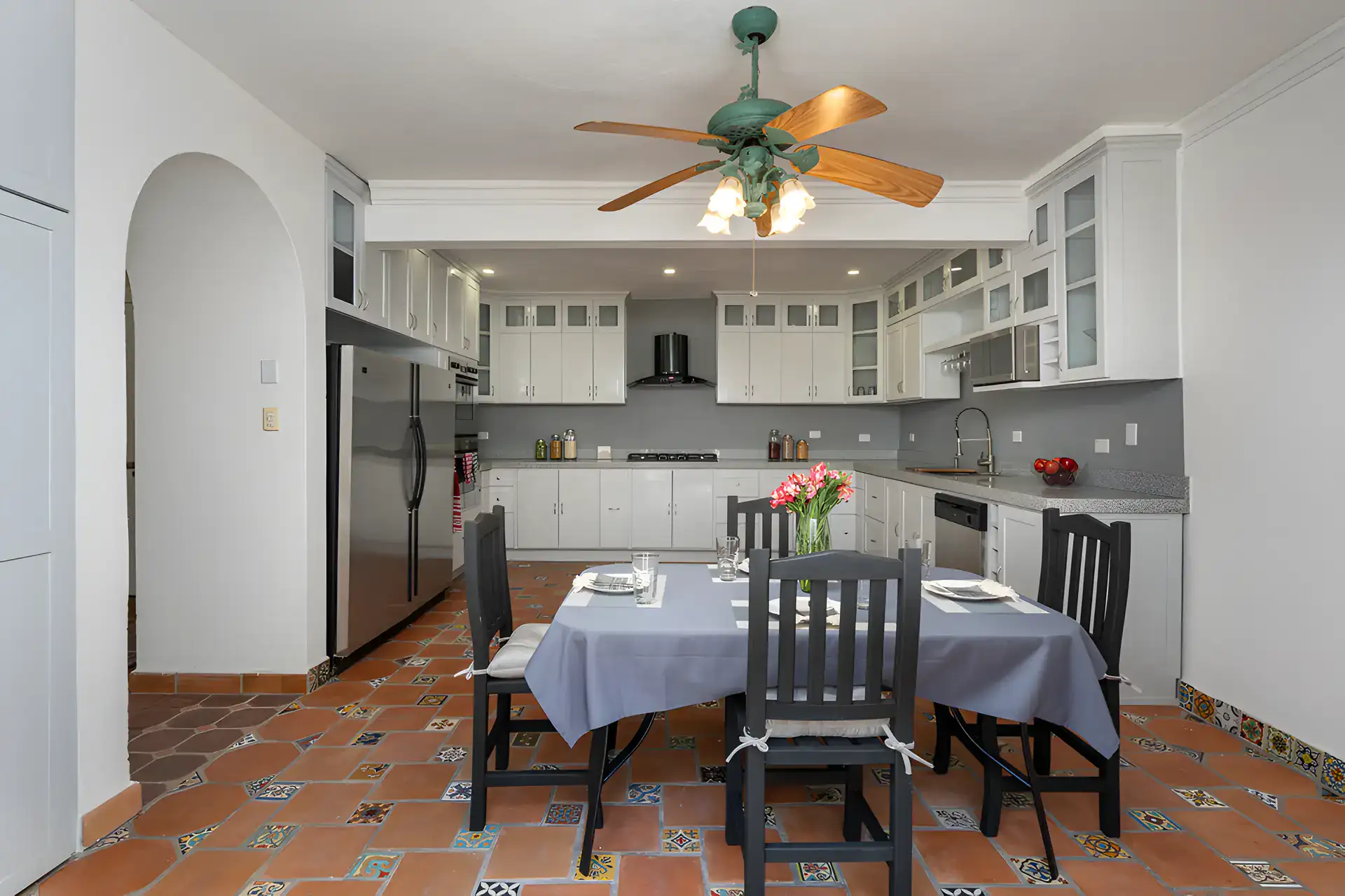 Villa Escondida, kitchen and dining table with a stainless refrigerator and a ceiling fan, San Miguel de Allende