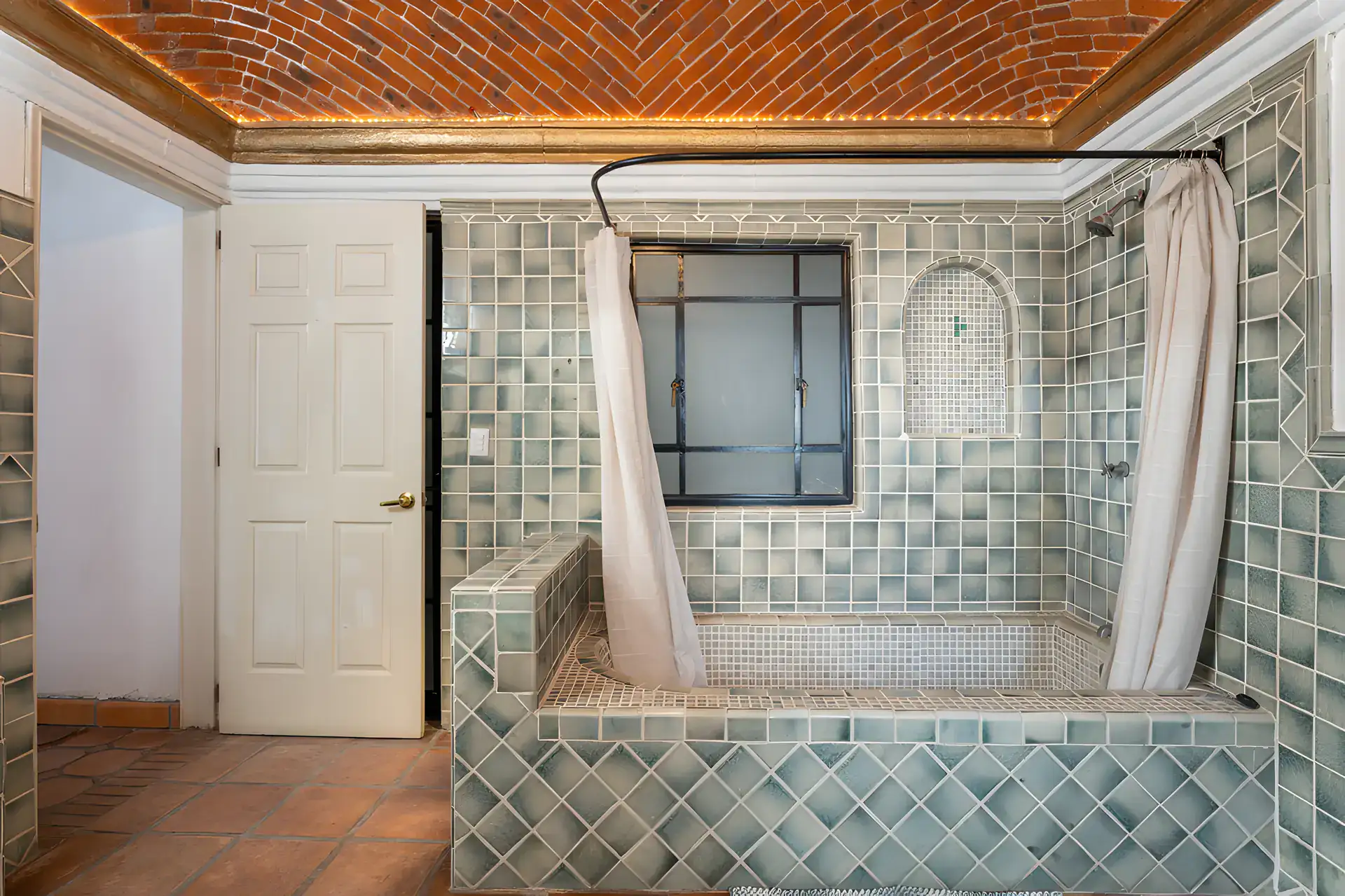 Villa Escondida, bathroom with a green tiled tub and shower and a small window, San Miguel de Allende