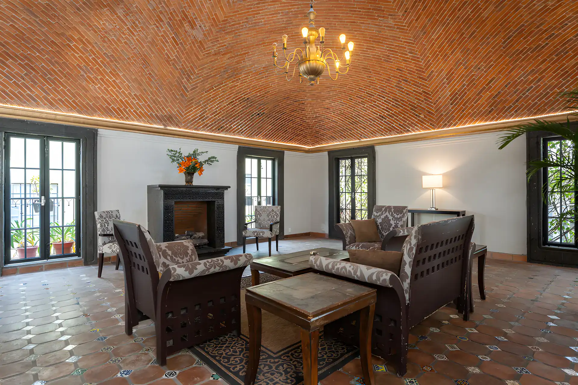 Villa Escondida, living room seating area facing a fireplace with French doors on both sides, San Miguel de Allende