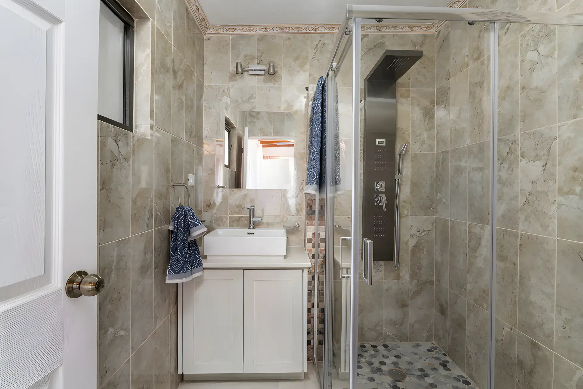 Villa Escondida, bathroom with a beige tile shower, shower panel and a vessel sink, San Miguel de Allende