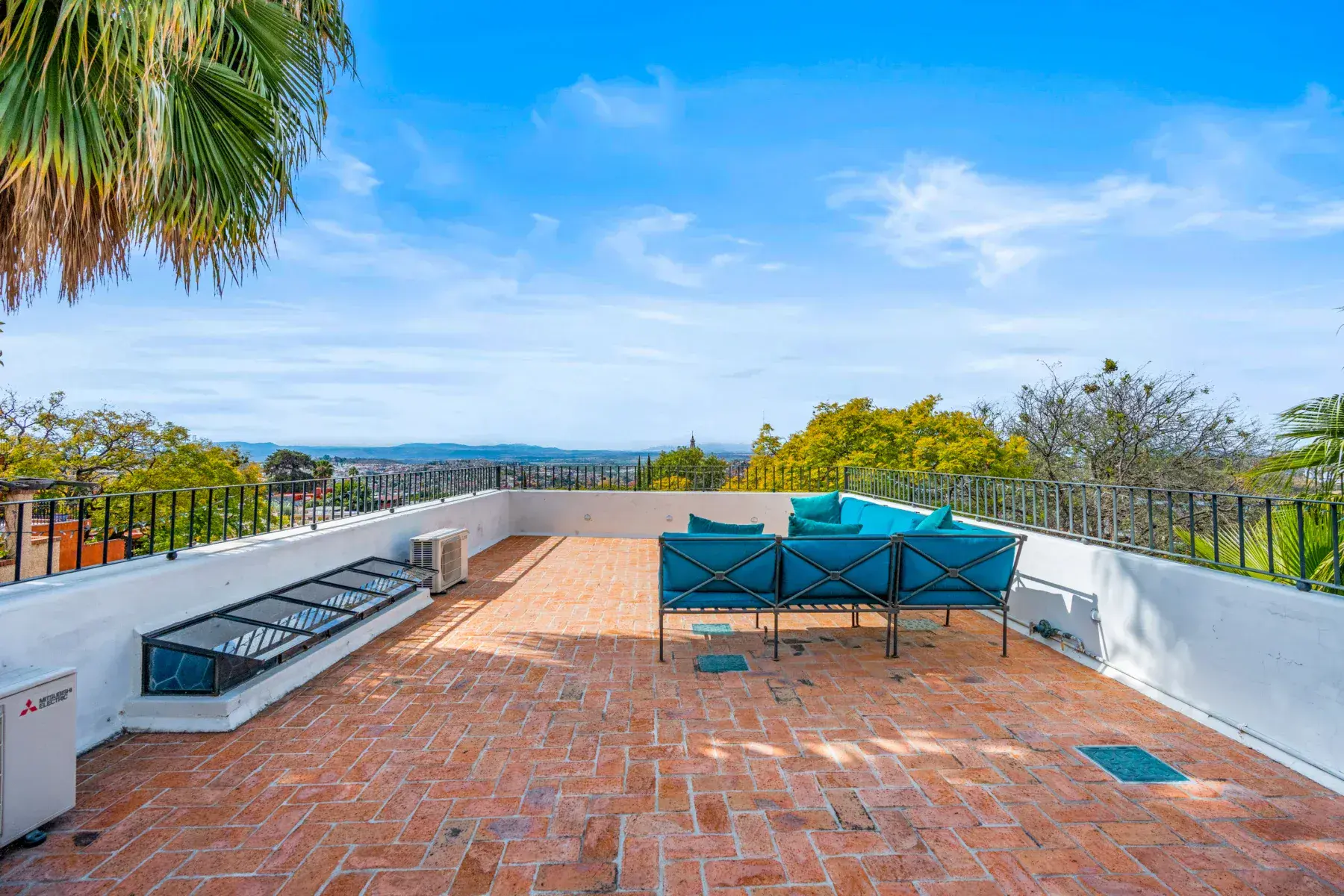 Villa Garita, rooftop terrace with a blue sectional and open views, San Miguel de Allende