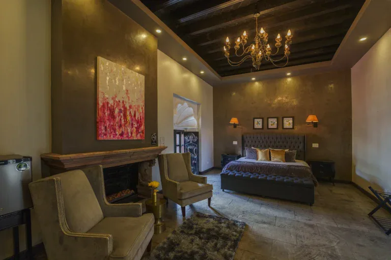 Villa Limón, suite with a seating area, fireplace and a chandelier, San Miguel de Allende