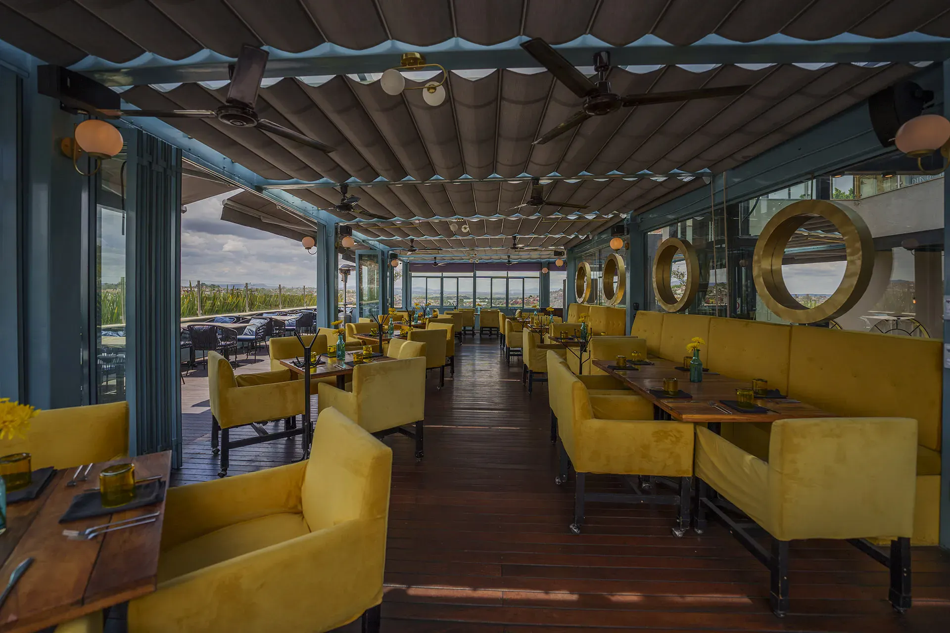 Villa Limón, rooftop restaurant with yellow banquettes and city views, San Miguel de Allende