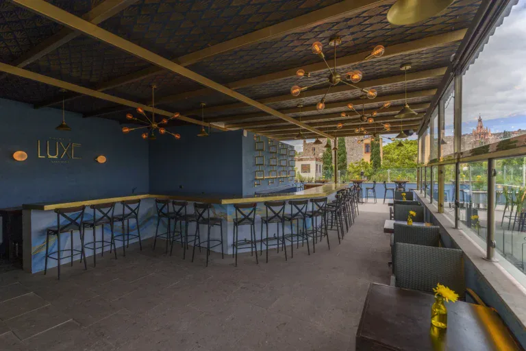 Villa Limón, rooftop bar with high stools under a wood ceiling, San Miguel de Allende