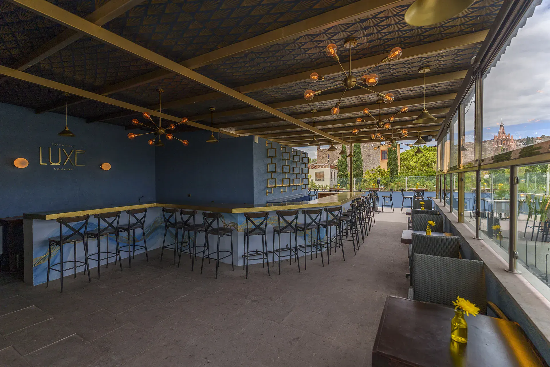 Villa Limón, rooftop bar with high stools under a wood ceiling, San Miguel de Allende
