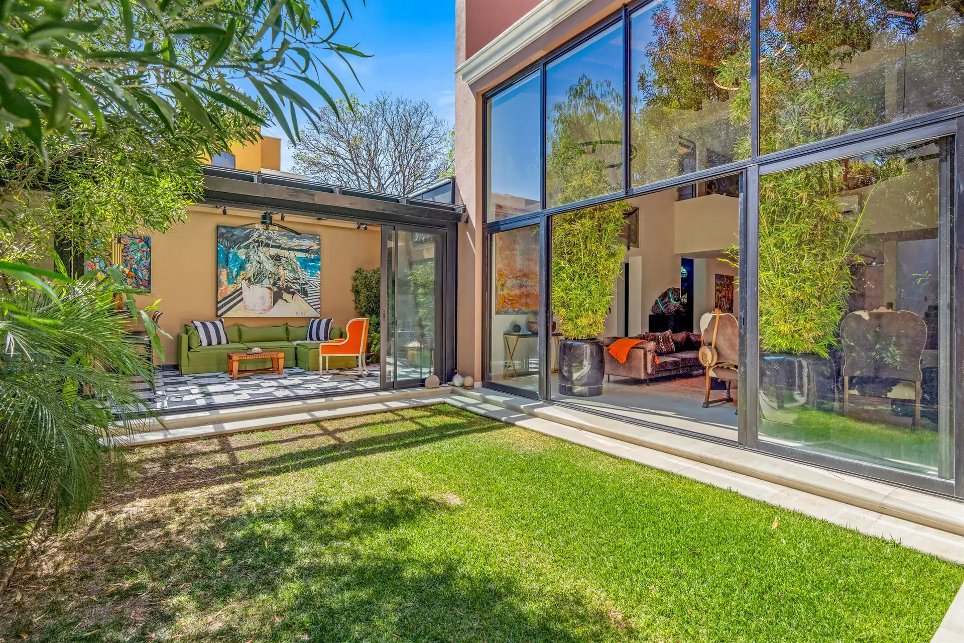Villa Pacifica, lawn view of the house with tall glass windows and a glass-roofed lounge, San Miguel de Allende