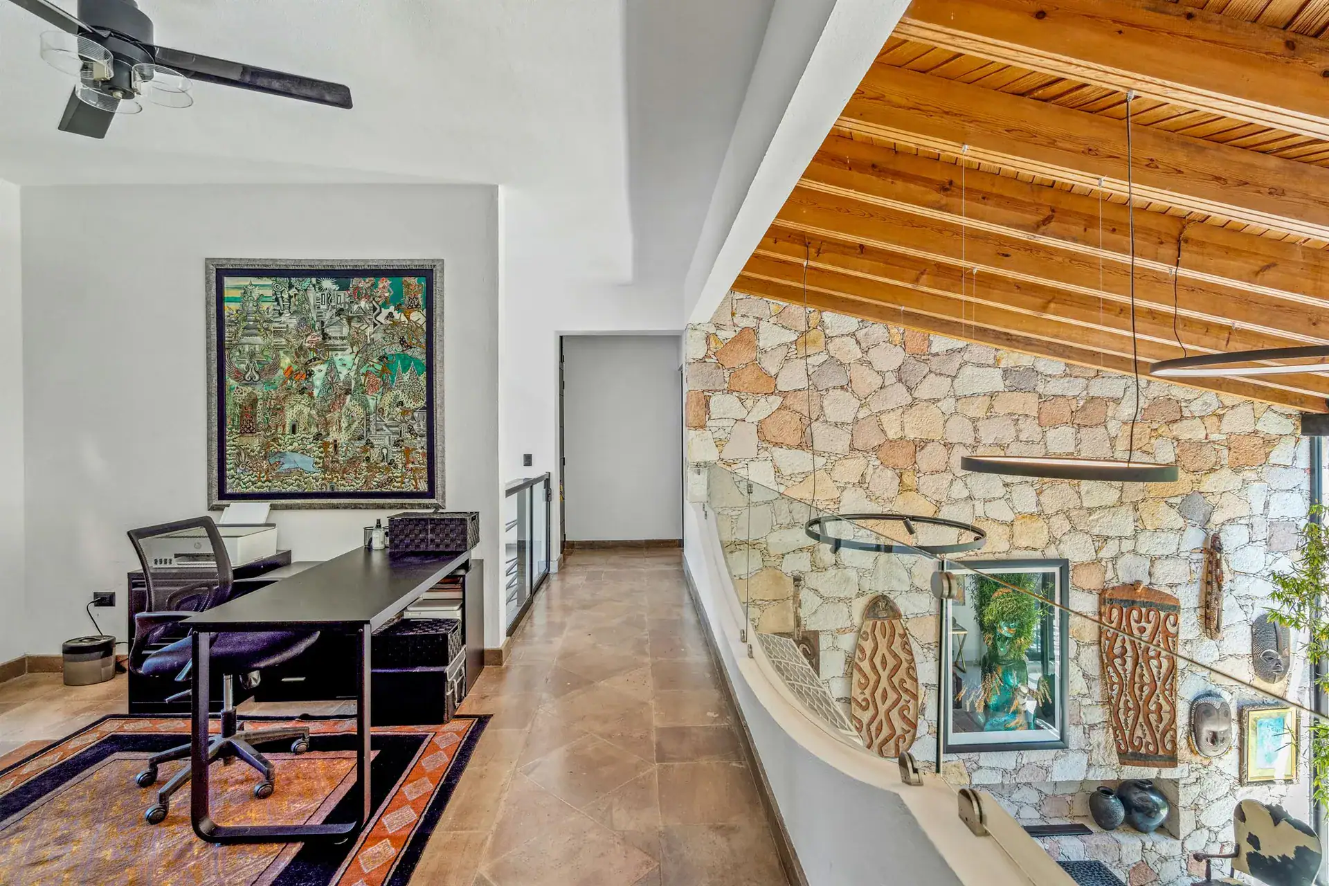 Villa Pacifica, upstairs office with a desk, a stone feature wall and a wood-slat ceiling, San Miguel de Allende