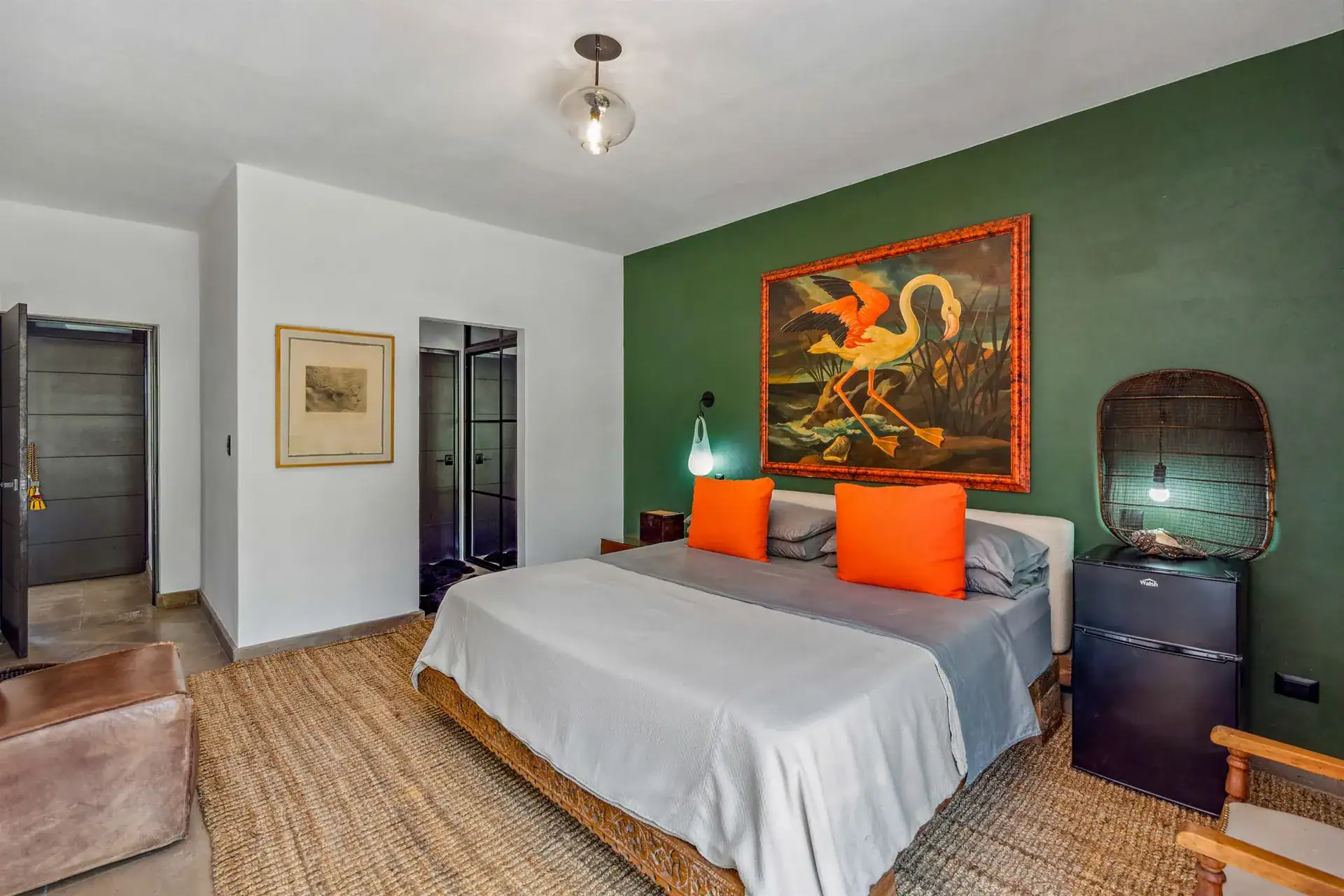 Villa Pacifica, bedroom with a green feature wall, a woven headboard and a black mini fridge, San Miguel de Allende