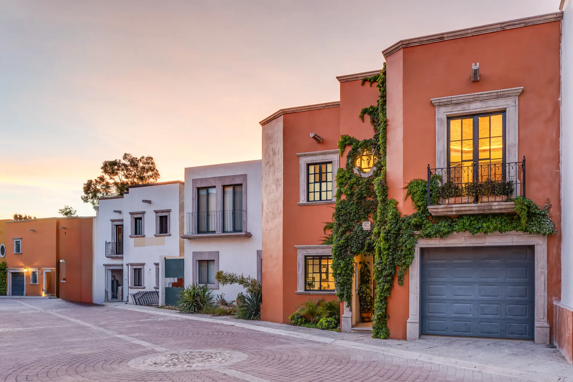 Villa Van Gogh, orange stucco townhouse with a vine-covered balcony and a garage, San Miguel de Allende