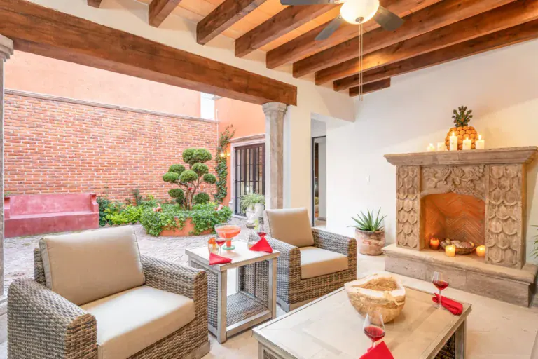 Villa Van Gogh, covered patio seating with a stone fireplace, San Miguel de Allende