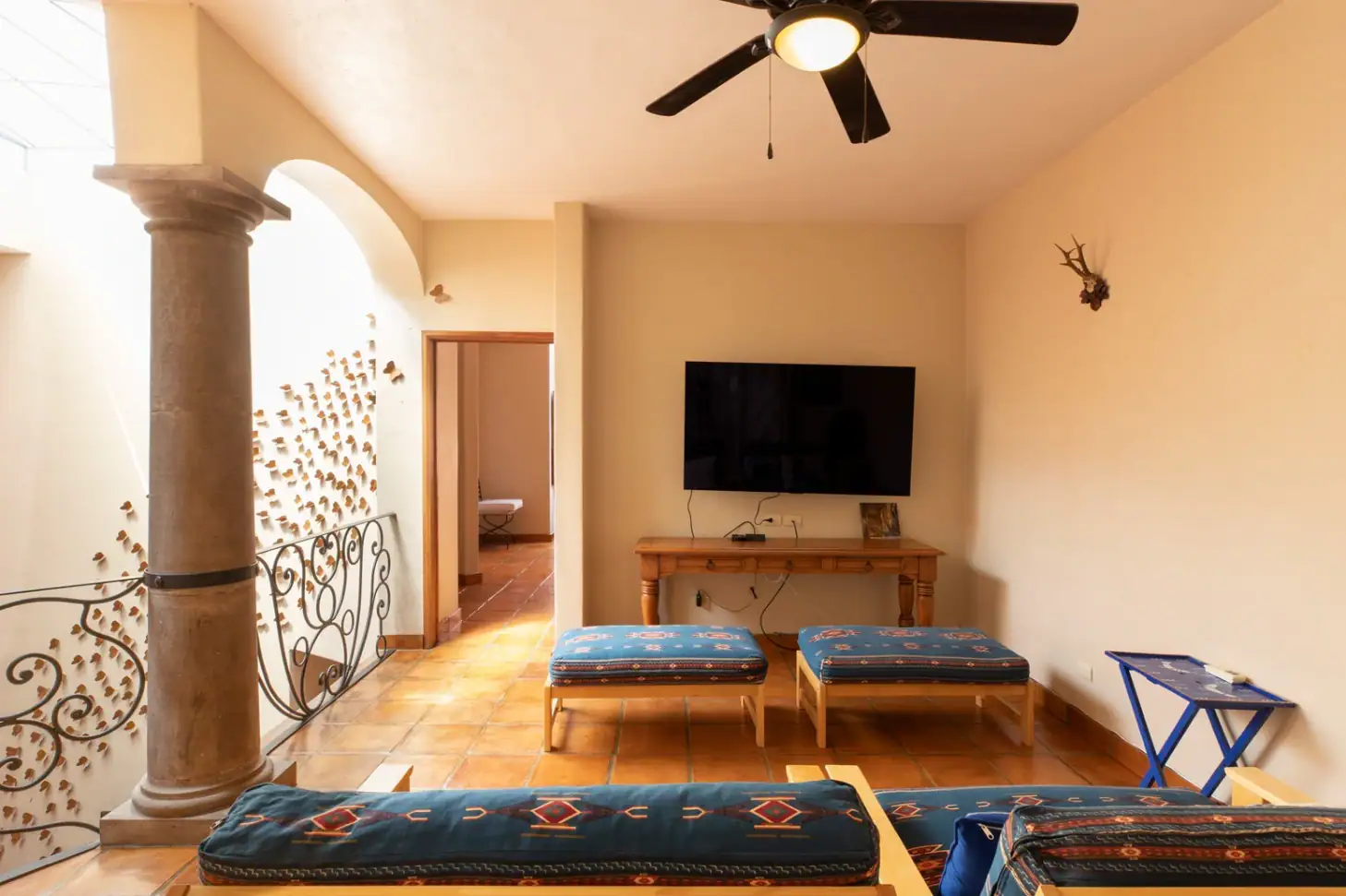 Casa Brillante, family room with a television and blue cushioned benches, San Miguel de Allende